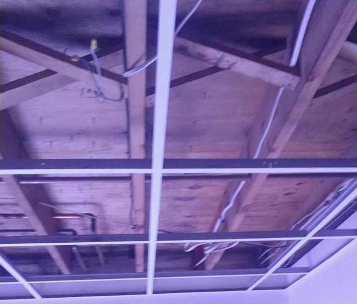 panels in drop ceiling removed and plywood ceiling exposed